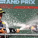 SPA, BELGIUM - AUGUST 28: Race winner Max Verstappen of the Netherlands and Oracle Red Bull Racing and Second placed Sergio Perez of Mexico and Oracle Red Bull Racing celebrate on the podium during the F1 Grand Prix of Belgium at Circuit de Spa-Francorchamps on August 28, 2022 in Spa, Belgium. (Photo by Mark Thompson/Getty Images)