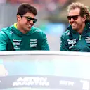 BUDAPEST, HUNGARY - JULY 31: Sebastian Vettel of Germany and Aston Martin F1 Team and Lance Stroll of Canada and Aston Martin F1 Team look on from the drivers parade ahead of the F1 Grand Prix of Hungary at Hungaroring on July 31, 2022 in Budapest, Hungary. (Photo by Mark Thompson/Getty Images)