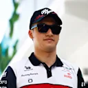 MIAMI, FLORIDA - MAY 08: Zhou Guanyu of China and Alfa Romeo F1 walks in the Paddock prior to the F1 Grand Prix of Miami at the Miami International Autodrome on May 08, 2022 in Miami, Florida. (Photo by Jared C. Tilton/Getty Images)