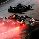 SINGAPORE, SINGAPORE - OCTOBER 02: Max Verstappen of the Netherlands driving the (1) Oracle Red Bull Racing RB18 and Kevin Magnussen of Denmark driving the (20) Haas F1 VF-22 Ferrari battle for track position during the F1 Grand Prix of Singapore at Marina Bay Street Circuit on October 02, 2022 in Singapore, Singapore. (Photo by Clive Mason/Getty Images,)