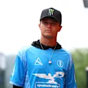 Lando walks the paddock ahead of the 2025 Belgian Grand Prix wearing a jersey style shirt from his own brand Quadrant. Swipe to see more