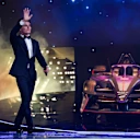 Norris arrives on stage at the awards ceremony