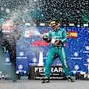 MIAMI, FLORIDA - MAY 07: Race winner Max Verstappen of the Netherlands and Oracle Red Bull Racing and Third placed Fernando Alonso of Spain and Aston Martin F1 Team celebrate on the podium during the F1 Grand Prix of Miami at Miami International Autodrome on May 07, 2023 in Miami, Florida. (Photo by Dan Istitene - Formula 1/Formula 1 via Getty Images)