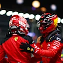 SINGAPORE, SINGAPORE - SEPTEMBER 16: Pole position qualifier Carlos Sainz of Spain and Ferrari celebrates with team-mate and third placed qualifier Charles Leclerc of Monaco and Ferrari in parc ferme during qualifying ahead of the F1 Grand Prix of Singapore at Marina Bay Street Circuit on September 16, 2023 in Singapore, Singapore. (Photo by Dan Istitene - Formula 1/Formula 1 via Getty Images)