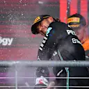 AUSTIN, TEXAS - OCTOBER 22: Second placed Lewis Hamilton of Great Britain and Mercedes celebrates on the podium during the F1 Grand Prix of United States at Circuit of The Americas on October 22, 2023 in Austin, Texas. (Photo by Rudy Carezzevoli/Getty Images)