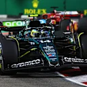 SINGAPORE, SINGAPORE - SEPTEMBER 22: Fernando Alonso of Spain driving the (14) Aston Martin AMR24 Mercedes leads Charles Leclerc of Monaco driving the (16) Ferrari SF-24 on track during the F1 Grand Prix of Singapore at Marina Bay Street Circuit on September 22, 2024 in Singapore, Singapore. (Photo by Clive Rose - Formula 1/Formula 1 via Getty Images)
