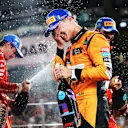 ABU DHABI, UNITED ARAB EMIRATES - DECEMBER 08: Race winner Lando Norris of Great Britain and McLaren celebrates on the podium during the F1 Grand Prix of Abu Dhabi at Yas Marina Circuit on December 08, 2024 in Abu Dhabi, United Arab Emirates. (Photo by Bryn Lennon - Formula 1/Formula 1 via Getty Images)