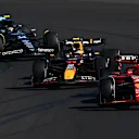 MELBOURNE, AUSTRALIA - MARCH 24: Charles Leclerc of Monaco driving the (16) Ferrari SF-24 leads Sergio Perez of Mexico driving the (11) Oracle Red Bull Racing RB20 and Fernando Alonso of Spain driving the (14) Aston Martin AMR24 Mercedes during the F1 Grand Prix of Australia at Albert Park Circuit on March 24, 2024 in Melbourne, Australia. (Photo by Clive Mason - Formula 1/Formula 1 via Getty Images)