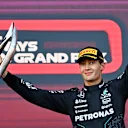 BAKU, AZERBAIJAN - SEPTEMBER 15: Third placed George Russell of Great Britain and Mercedes celebrates on the podium during the F1 Grand Prix of Azerbaijan at Baku City Circuit on September 15, 2024 in Baku, Azerbaijan. (Photo by James Sutton/Getty Images)