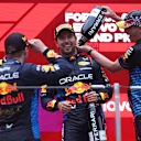 SHANGHAI, CHINA - APRIL 21: Race winner Max Verstappen of the Netherlands and Oracle Red Bull Racing, Third placed Sergio Perez of Mexico and Oracle Red Bull Racing and Oracle Red Bull Racing Head of Car Engineering Paul Monaghan celebrate on the podium during the F1 Grand Prix of China at Shanghai International Circuit on April 21, 2024 in Shanghai, China. (Photo by Lars Baron/Getty Images)