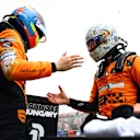 BUDAPEST, HUNGARY - JULY 20: Pole position qualifier Lando Norris of Great Britain and McLaren and Second placed qualifier Oscar Piastri of Australia and McLaren celebrate in parc ferme during qualifying ahead of the F1 Grand Prix of Hungary at Hungaroring on July 20, 2024 in Budapest, Hungary. (Photo by Bryn Lennon - Formula 1/Formula 1 via Getty Images)