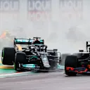IMOLA, ITALY - APRIL 18: Lewis Hamilton of Great Britain driving the (44) Mercedes AMG Petronas F1 Team Mercedes W12 drives off a raised kerb behind Max Verstappen of the Netherlands driving the (33) Red Bull Racing RB16B Honda during the F1 Grand Prix of Emilia Romagna at Autodromo Enzo e Dino Ferrari on April 18, 2021 in Imola, Italy. (Photo by Bryn Lennon/Getty Images)