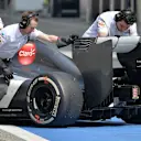 Engineers with protective rubber gloves push the car of Esteban Gutierrez (MEX) Sauber C33 into the garage. Formula One Testing, Day Two, Bahrain International Circuit, Sakhir, Bahrain, Friday, 28 February 2014© Sutton Images. No reproduction without permission