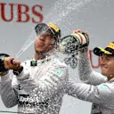 Lewis Hamilton (GBR) Mercedes AMG F1 and Nico Rosberg (GER) Mercedes AMG F1 celebrate on the podium with the champagne. Formula One World Championship, Rd4, Chinese Grand Prix, Race, Shanghai, China, Sunday, 20 April 2014