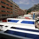 The teams' motorhomes are squeezed between buildings and the harbour in the paddock