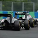 Jenson Button (GBR) McLaren MP4-29 and Adrian Sutil (GER) Sauber C33. Formula One World Championship, Rd11, Hungarian Grand Prix, Race Day, Hungaroring, Hungary. Sunday, 27 July 2014 © Sutton Images. No reproduction without permission