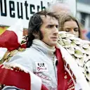 Jackie Stewart (GBR) Tyrrell celebrates his twenty-seventh and final GP victory on the podium. German Grand Prix, Nurburgring, 5 August 1973. © Sutton Images. No reproduction without permission