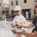 2014 title contender Lewis Hamilton signs an autograph on his way to the Mercedes garage ahead of FP3 © FOWC Ltd. No reproduction without permission.