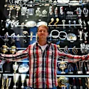 Outgoing Red Bull driver Sebastian Vettel poses with some of the trophies he won, Red Bull factory, Milton Keynes, December 2 2014. © Red Bull