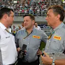 (L to R): Eric Boullier (FRA) McLaren Racing Director, Paul Hembery (GBR) Pirelli Motorsport Director and Mario Isola (ITA) Pirelli Sporting Director on the grid. Formula One World Championship, Rd3, Bahrain Grand Prix, Race, Bahrain International Circuit, Sakhir, Bahrain, Sunday, 6 April 2014. © Sutton Images