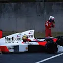 Alain Prost (FRA) McLaren MP4/5 walks from his car following a collision with team mate Ayrton Senna (BRA) at the entrance to the chicane. Meanwhile Senna pleads with the marshals to push start him. They did, he recovered to win, but was disqualified. Formula One World Championship, Japanese Grand Prix, Suzuka, Japan. 22 October 1989. © Sutton Images