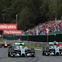 (L to R): Lewis Hamilton (GBR) Mercedes AMG F1 W05 and Nico Rosberg (GER) Mercedes AMG F1 W05 battle at Les Coombes on lap 2. Rosberg damaged his front wing and punctured the left rear wheel of Hamilton's car in the process. Formula One World Championship, Rd12, Belgian Grand Prix, Race Day, Spa-Francorchamps, Belgium, Sunday, 24 August 2014. © Sutton Images