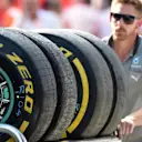 Mercedes AMG F1 mechanic with Pirelli tyres. Formula One World Championship, Rd11, Hungarian Grand Prix, Practice, Hungaroring, Hungary. Friday, 25 July 2014