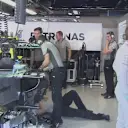 Nico Rosberg watches the action from the Mercedes garage, while his mechanics work on a gearbox issue that rules him out of FP3. © FOWC Ltd