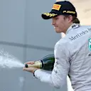 Nico Rosberg (GER) Mercedes AMG F1 celebrates on the podium with the champagne. Formula One World Championship, Rd16, Russian Grand Prix, Race, Sochi Autodrom, Sochi, Krasnodar Krai, Russia, Sunday, 12 October 2014