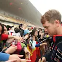 Sebastian Vettel (GER) Red Bull Racing signs autographs for the fans. Formula One World Championship, Rd4, Chinese Grand Prix, Preparations, Shanghai, China, Thursday, 17 April 2014