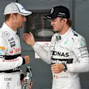 Jenson Button (GBR) McLaren and pole sitter Nico Rosberg (GER) Mercedes AMG F1 celebrate in parc ferme. Formula One World Championship, Rd9, British Grand Prix, Qualifying, Silverstone, England, Saturday, 5 July 2014