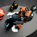 Lewis Hamilton, Mercedes-AMG Petronas F1, 1st position, on the podium with his trophy and the helmet of Michael Schumacher