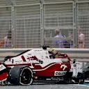 Alfa Romeo's Finnish driver Kimi Raikkonen stands by is car after he crashed at the Yas Marina Circuit during the second free practice session of the Abu Dhabi Formula One Grand Prix on December 10, 2021. (Photo by Giuseppe CACACE / AFP) (Photo by GIUSEPPE CACACE/AFP via Getty Images)