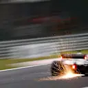 Sparks fly from the rear of Romain Grosjean, Haas VF-20