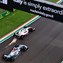 Haas F1 Team's Danish driver Kevin Magnussen (top) and Mercedes' British driver George Russell steer during the Emilia Romagna Formula One Grand Prix at the Autodromo Internazionale Enzo e Dino Ferrari race track in Imola, Italy, on April 24, 2022. (Photo by ANDREJ ISAKOVIC / AFP) (Photo by ANDREJ ISAKOVIC/AFP via Getty Images)