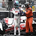 Haas F1 Team's German driver Mick Schumacher (L) is asisted by a race marshal after crashing during the Monaco Formula 1 Grand Prix at the Monaco street circuit in Monaco, on May 29, 2022. (Photo by LOIC VENANCE / AFP) (Photo by LOIC VENANCE/AFP via Getty Images)