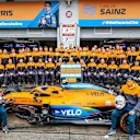 Sainz and Norris pose with the MCL35 and their team for World Mental Health Day. The team and their fans have raised nearly £200k since July for the charity Mind.
