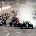 BAKU, AZERBAIJAN - JUNE 06: Lewis Hamilton of Great Britain driving the (44) Mercedes AMG Petronas F1 Team Mercedes W12 locks up under pressure from Sergio Perez of Mexico driving the (11) Red Bull Racing RB16B Honda into the first corner after the restart following a red flag period during the F1 Grand Prix of Azerbaijan at Baku City Circuit on June 06, 2021 in Baku, Azerbaijan. (Photo by Clive Rose/Getty Images)