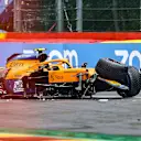 TOPSHOT - Race marshalls and technicians clear the car McLaren's British driver Lando Norris after he crashed unthe qualifying session of the Formula One Belgian Grand Prix at the Spa-Francorchamps circuit in Spa on August 28, 2021. (Photo by KENZO TRIBOUILLARD / AFP) (Photo by KENZO TRIBOUILLARD/AFP via Getty Images)
