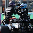 BUDAPEST, HUNGARY - JULY 31: Pole position qualifier Lewis Hamilton of Great Britain and Mercedes GP and second place qualifier Valtteri Bottas of Finland and Mercedes GP celebrate in parc ferme during qualifying ahead of the F1 Grand Prix of Hungary at Hungaroring on July 31, 2021 in Budapest, Hungary. (Photo by Bryn Lennon/Getty Images)