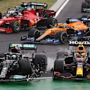 TOPSHOT - Mercedes' Finnish driver Valtteri Bottas collides with Red Bull's Mexican driver Sergio Perez during the Formula One Hungarian Grand Prix at the Hungaroring race track in Mogyorod near Budapest on August 1, 2021. (Photo by Peter Kohalmi / POOL / AFP) (Photo by PETER KOHALMI/POOL/AFP via Getty Images)
