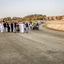 Another view of the banked Turn 13 corner at Jeddah, with media inspecting the site