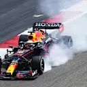 A spectacular puff of smoke emitted by Verstappen's RB16B as he locks up