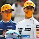 Something catches the eyes of the McLaren drivers as they pose for a grid photo in the morning. Daniel Ricciardo (R) took the wheel first