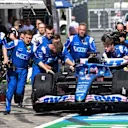 Mechanics move the car of Alpine's Spanish driver Fernando Alonso prior to the sprint qualifying at the Red Bull Ring race track in Spielberg, Austria, on July 9, 2022, ahead of the Formula One Austrian Grand Prix. (Photo by CHRISTIAN BRUNA / POOL / AFP) (Photo by CHRISTIAN BRUNA/POOL/AFP via Getty Images)
