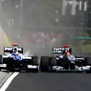 Michael Schumacher (GER) Mercedes GP MGP W01 squeezes Rubens Barrichello (BRA) Williams FW32 into the pit wall and onto the grass.
Hungarian Grand Prix, Race, Budapest, Hungary, Sunday 1 August 2010. ©  Sutton Motorsport Images