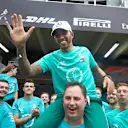 Lewis Hamilton, Mercedes AMG F1, on the shoulders of Ron Meadows, Sporting Director, Mercedes AMG, celebrates with the Mercedes team during the Brazilian GP at Autódromo José Carlos Pace on November 11, 2018. (Photo by Steve Etherington / LAT Images)