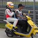 Lewis Hamilton hitches a ride on a scooter after retiring from the 2007 Chinese Grand Prix. Shanghai International Circuit, Shanghai, China
7th October 2007. World Copyright: Steve Etherington/LAT Photographic