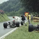 Graham Hill's famous gesture at Rouen, where he lent his visor to Jo Siffert mid-race © LAT Photographic