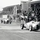 Hans Stuck Snr, in the #2 Auto Union Type C, leads the start of the 1936 Italian Grand Prix at Monza from Bernd Rosemeyer, #4 Auto Union, Tazio Nuvolari, #18 Alfa Romeo, Achille Varzi, #6 Auto Union, Ernst von Delius, #8 Auto Union, and Giuseppe Farina, #22 Alfa Romeo